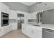 Kitchen with stainless steel appliances, wine rack, island, and gray backsplash at 600 Eagle Watch Ln, Osprey, FL 34229