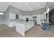 Open kitchen features a large island, stainless steel appliances, and modern lighting at 600 Eagle Watch Ln, Osprey, FL 34229