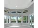 Living Room featuring arched windows overlooking the pool and landscaped backyard at 600 Eagle Watch Ln, Osprey, FL 34229