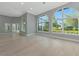 Spacious living room with arched windows, light wood flooring and neutral walls at 600 Eagle Watch Ln, Osprey, FL 34229