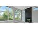 Bright living room featuring large arched windows, fireplace with black tile surround, and gray walls at 600 Eagle Watch Ln, Osprey, FL 34229