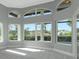 Arched windows bring natural light into this spacious living room with view of pool at 600 Eagle Watch Ln, Osprey, FL 34229