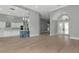 Open concept living space with light hardwood floors and views of the front entrance at 600 Eagle Watch Ln, Osprey, FL 34229