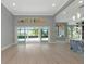 Spacious living room with patio views, hardwood floors, and access to the bar area at 600 Eagle Watch Ln, Osprey, FL 34229