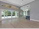 Expansive living room featuring hardwood floors, a bar, and sliding glass doors to the pool at 600 Eagle Watch Ln, Osprey, FL 34229