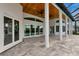 Covered outdoor patio with ceiling fans, columns, and tiled flooring, perfect for entertaining or relaxing outdoors at 600 Eagle Watch Ln, Osprey, FL 34229