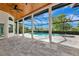 Screened-in patio area featuring a private pool, spa, and beautiful backyard views at 600 Eagle Watch Ln, Osprey, FL 34229