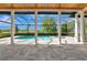 Screened patio area with a private pool and scenic backyard views at 600 Eagle Watch Ln, Osprey, FL 34229