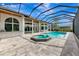 Luxurious screened-in pool and spa area with a large pool, attached spa, and ample patio space for lounging at 600 Eagle Watch Ln, Osprey, FL 34229
