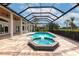 Stunning screened-in pool and spa area featuring a pool, spa, and expansive deck for outdoor relaxation and entertainment at 600 Eagle Watch Ln, Osprey, FL 34229