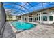 Spacious screened-in pool area with a pool, spa, and ample deck space, ideal for enjoying the outdoors at 600 Eagle Watch Ln, Osprey, FL 34229