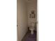 Clean bathroom with toilet, wall shelving, and tiled floor at 615 Sunlit Coral St, Ruskin, FL 33570