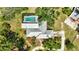 Aerial view of home with a screened-in pool, mature trees and lush landscape at 6540 Prairie Junction Trl, Sarasota, FL 34241