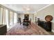 Elegant dining room featuring hardwood floors, a stylish chandelier, and large windows with lots of natural light at 6540 Prairie Junction Trl, Sarasota, FL 34241