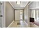 Inviting foyer with neutral paint, tiled floors, and a glass paneled front door at 6540 Prairie Junction Trl, Sarasota, FL 34241