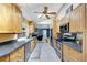 Bright kitchen with wooden cabinets, granite countertops, and stainless steel appliances at 6540 Prairie Junction Trl, Sarasota, FL 34241