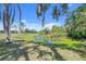 Scenic view of a lily pad-covered pond shaded by trees, adding a touch of nature to the property at 6540 Prairie Junction Trl, Sarasota, FL 34241