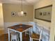 Cozy dining room featuring wainscoting, a stylish light fixture, and an ornate mirror at 6703 Midnight Pass Rd # 206, Sarasota, FL 34242