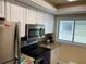 Well-lit kitchen featuring stainless steel appliances, granite countertops, and white cabinets at 6703 Midnight Pass Rd # 206, Sarasota, FL 34242