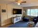 Cozy living room with comfortable seating, a large television, and a ceiling fan at 6703 Midnight Pass Rd # 206, Sarasota, FL 34242
