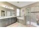 Luxurious bathroom with double vanity, soaking tub, and a separate glass-enclosed shower at 736 Rosemary Cir, Bradenton, FL 34212