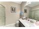 Neutral bathroom featuring a tiled shower, vanity with storage, and bright lighting at 736 Rosemary Cir, Bradenton, FL 34212