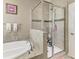 Elegant bathroom featuring a soaking tub, a glass-enclosed shower, and stylish tile work at 736 Rosemary Cir, Bradenton, FL 34212