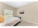 Bedroom featuring carpet flooring, neutral paint, a flatscreen TV, and a window overlooking the yard at 736 Rosemary Cir, Bradenton, FL 34212