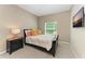 Comfortable bedroom featuring carpet flooring, a ceiling fan, and a flatscreen TV at 736 Rosemary Cir, Bradenton, FL 34212
