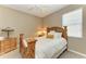 Cozy bedroom with wood furnishings, ceiling fan, and natural light from the window at 736 Rosemary Cir, Bradenton, FL 34212
