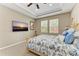 Bright bedroom featuring a tray ceiling, carpet flooring, and large windows offering natural light at 736 Rosemary Cir, Bradenton, FL 34212