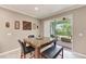 Bright dining area features a table with bench seating and sliding glass doors to the screened patio at 736 Rosemary Cir, Bradenton, FL 34212