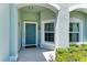 Welcoming front porch with a teal front door, window, and quaint decor at 736 Rosemary Cir, Bradenton, FL 34212