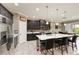 The kitchen features a central island, modern appliances, and stylish dark cabinetry for a modern feel at 736 Rosemary Cir, Bradenton, FL 34212