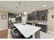 Elegant kitchen features dark cabinetry, a spacious island, and modern appliances that compliment the tile flooring at 736 Rosemary Cir, Bradenton, FL 34212