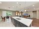 Open concept kitchen with island connects to living room, creating a seamless entertaining and living space at 736 Rosemary Cir, Bradenton, FL 34212