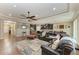 Open concept living area featuring a modern kitchen, hardwood flooring, and comfortable leather seating at 736 Rosemary Cir, Bradenton, FL 34212