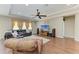 Bright living room with a large TV, comfortable seating, hardwood floors, and a ceiling fan at 736 Rosemary Cir, Bradenton, FL 34212