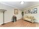 Inviting sitting room with wood floors, comfortable sofa, and a stylish Tiffany-style floor lamp at 736 Rosemary Cir, Bradenton, FL 34212