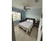 Bedroom view highlighting the neutral walls, ceiling fan, and comfortable-looking murphy bed at 7508 Mikasa Dr, Punta Gorda, FL 33950