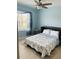 Bedroom featuring a murphy bed, window with blinds, and neutral-toned decor for a relaxing atmosphere at 7508 Mikasa Dr, Punta Gorda, FL 33950