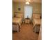 Cozy bedroom featuring two twin beds, a nightstand, and plenty of natural light at 7508 Mikasa Dr, Punta Gorda, FL 33950