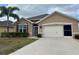 Charming single-story home featuring a well-maintained lawn, neutral paint, and an attached two-car garage at 7508 Mikasa Dr, Punta Gorda, FL 33950
