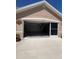 Open garage door showcasing ample space and storage potential at 7508 Mikasa Dr, Punta Gorda, FL 33950
