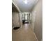 Hallway featuring tile flooring, neutral walls and a view of the front door at 7508 Mikasa Dr, Punta Gorda, FL 33950