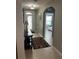 Hallway featuring tiled floors, an archway and a view of the decorative front door at 7508 Mikasa Dr, Punta Gorda, FL 33950