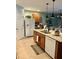 Bright kitchen featuring granite countertops, stainless steel appliances, and pendant lighting at 7508 Mikasa Dr, Punta Gorda, FL 33950