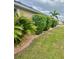 Well-maintained landscaping with trimmed bushes lining the house, offering curb appeal at 7508 Mikasa Dr, Punta Gorda, FL 33950