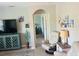 Bright living area featuring tile floors, comfortable seating, and a view into an adjacent bedroom through an arched doorway at 7508 Mikasa Dr, Punta Gorda, FL 33950