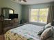 Serene main bedroom with large windows, a dresser, and a calming color scheme at 7508 Mikasa Dr, Punta Gorda, FL 33950